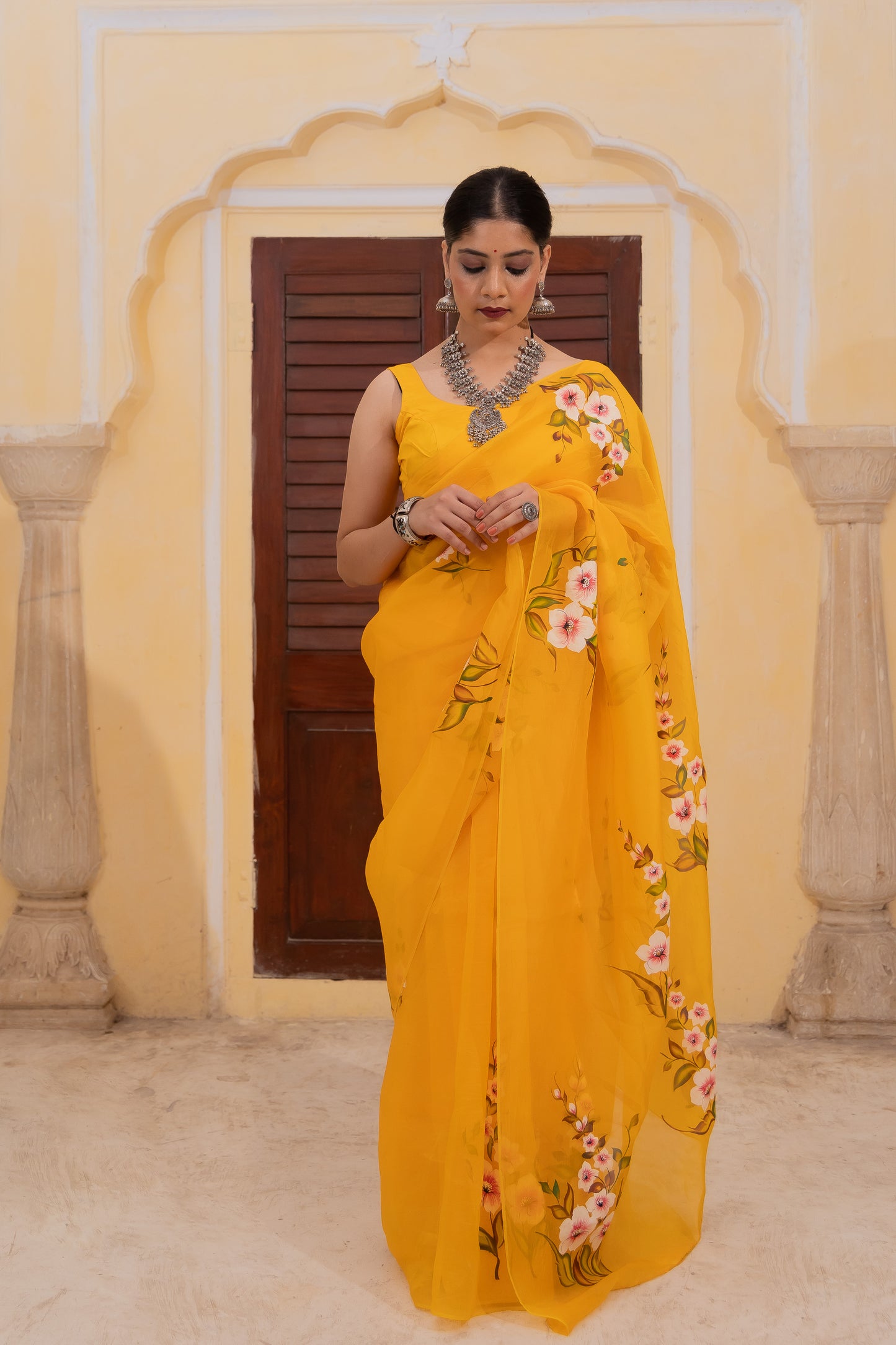 Radiate joy in this mango yellow silk organza saree adorned with vibrant florals 🌼✨ Perfect for brightening any occasion! 💛